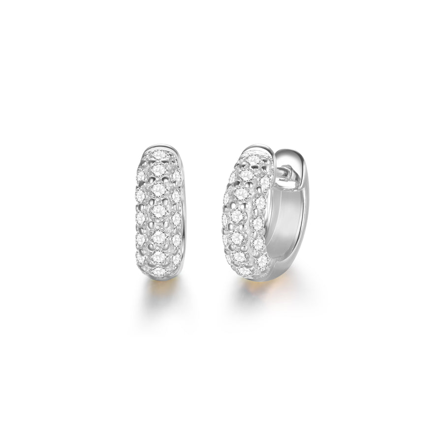 a pair of silver, huggie style hoop earrings with diamond stones 