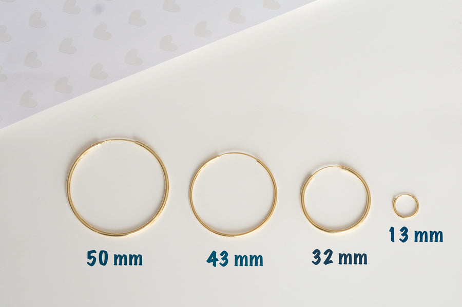 plain gold small hoops in sizes 13mm, 32mm, 43mm, and 50mm