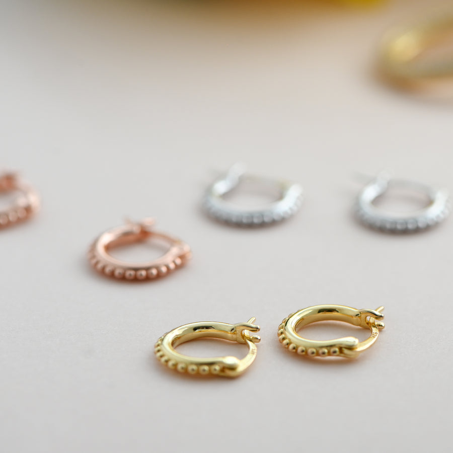 small gold hoops with small balls 