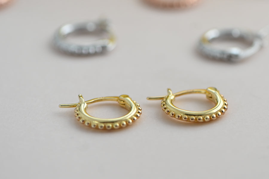 small, gold, beaded huggie hoop earrings with latch back closure
