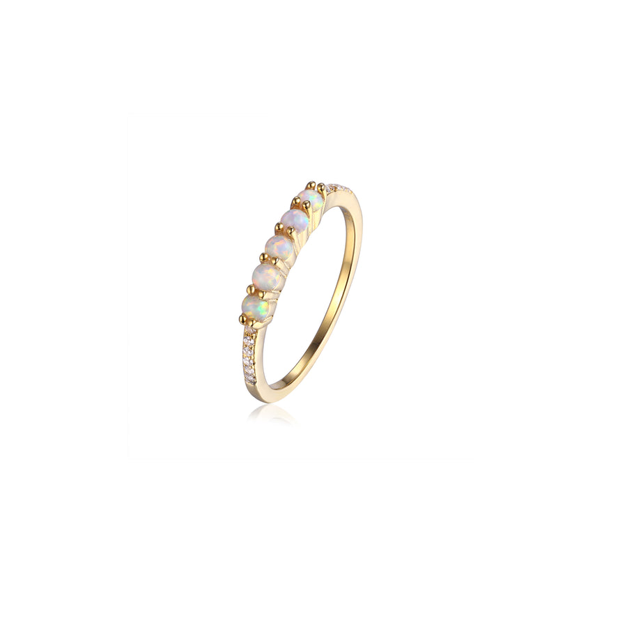 dainty gold opal stacking ring featuring 5 small opal stones set on a thin cubic zirconia pave band