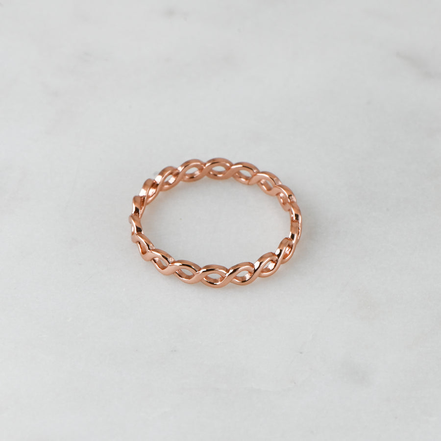 rose gold minimalist stacking ring featuring an eternity pattern