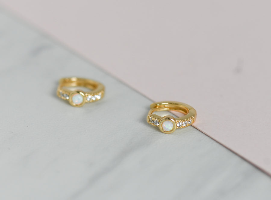 gold pair of diamond opal huggies